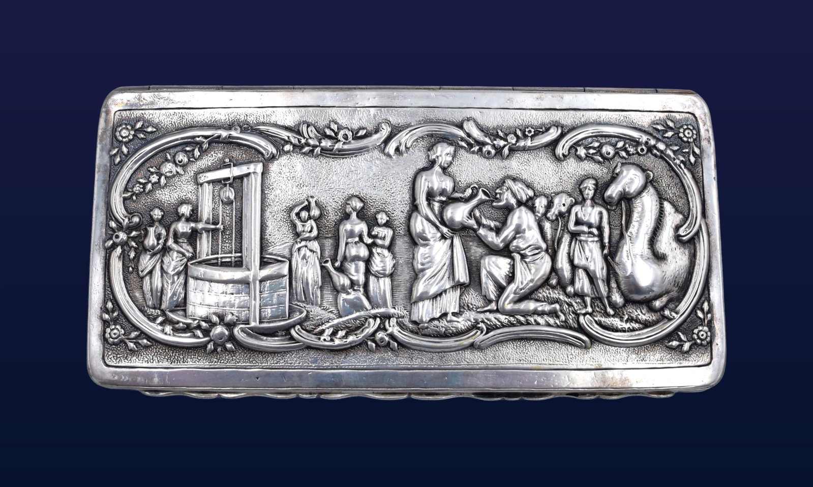 Continental Sterling Tobacco Box: Early 19th C. Hinged lid. Repousse figural scenes to lid and engraved decoration on base. Partially rubbed maker marks on side. 1 1/4" high x 6" wide x 3" deep. 7.25 ozt.Good condition consistent
