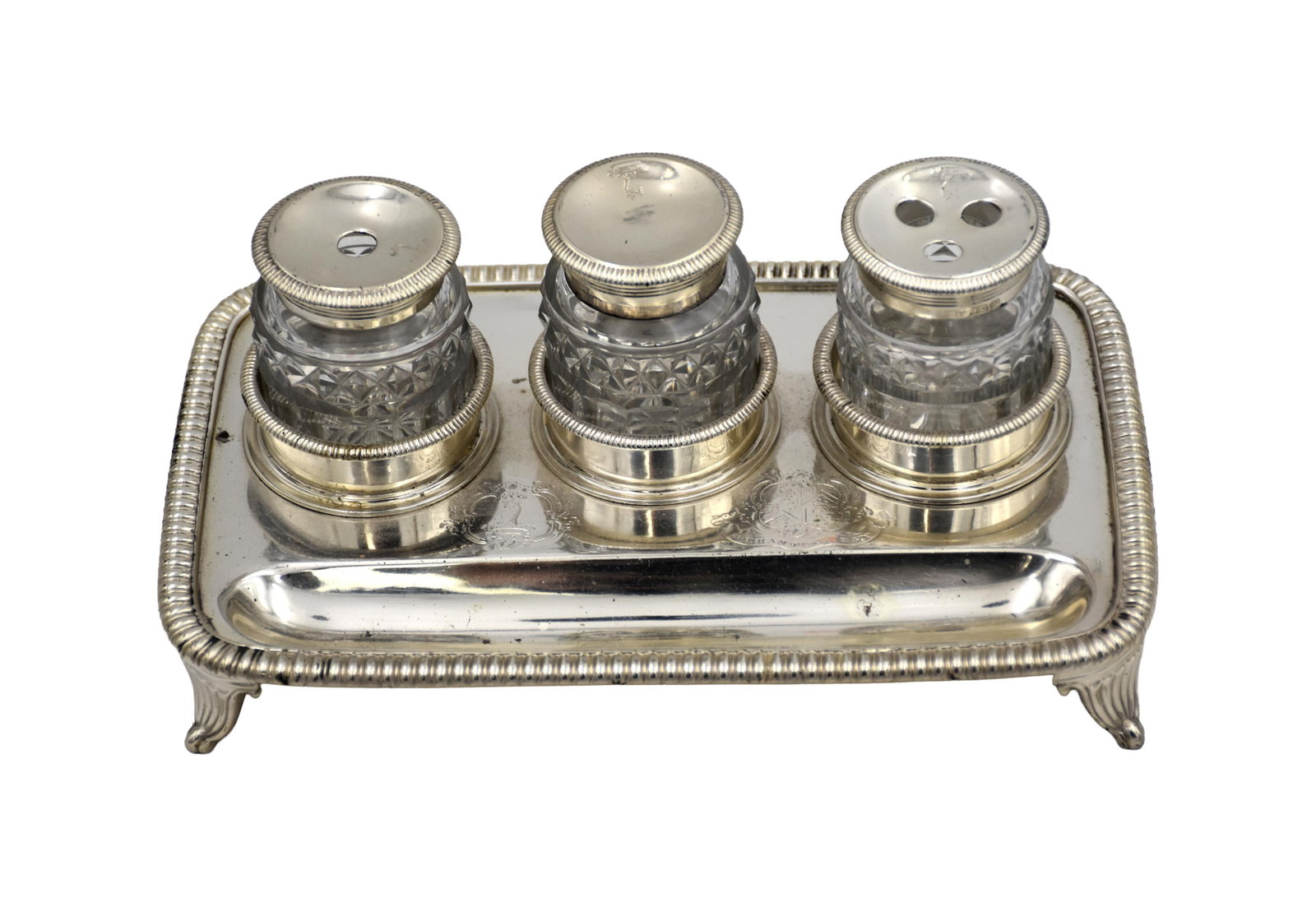 Sterling Silver Desk Stand: Late 19th C. Birmingham, Nathan & Hayes. Footed with three circular wells and long pen tray. Engraved armorials. Hallmarked on bottom. Along with three crystal and sterling inkwells. 2 1/4" high x 1 3