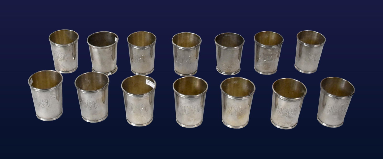 (14) Sterling Julep Cups: Early 20th C. Twelve matching cups with reeded trim and foot bands. Stamped "Newport Sterling" on bottoms. 3 1/2" high x 3" diameter. Along with two non-matching julep cups, one stamped "Fisher,