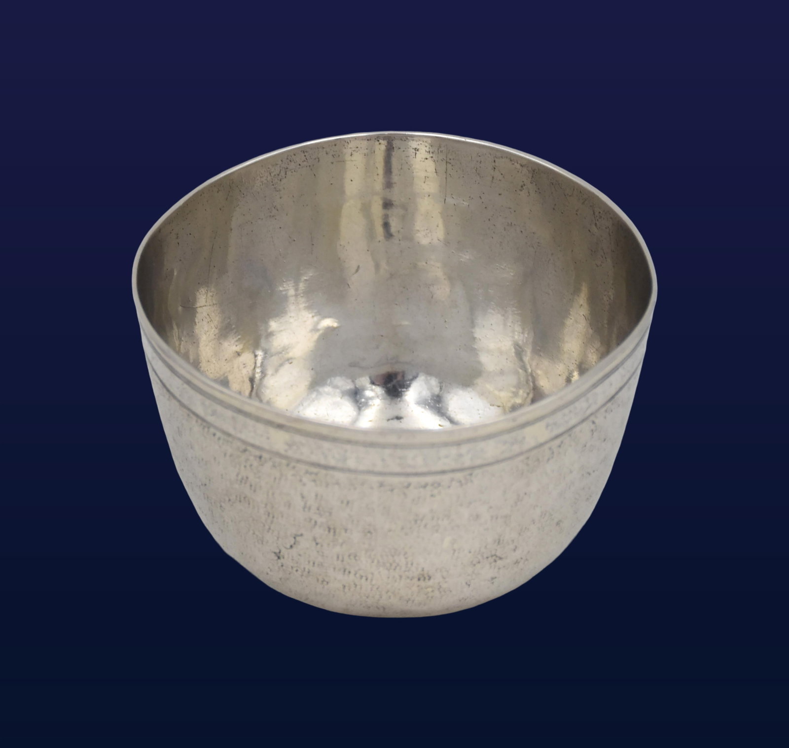 German Tumbler Cup: Ca. 1720. Made in Augsburg, Germany. Plain form with slight textured ground and threaded rim. Stamped with maker's mark "PS". (Paul Solanier) with slice across the initials. 1 3/4" high x 2 7/8" diame