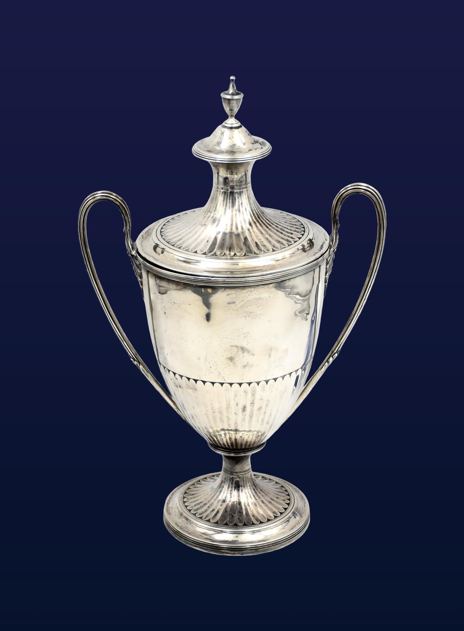 Sterling Silver Lidded Trophy Cup: Ca. 1810 British. Hallmarked on upper part of trophy near handle. Possibly Henry Chawner. Fluted lower body, domed cover, urn-form finial. 14 1/2" high x 9" wide handle-to-handle x 5 3/4" diameter at