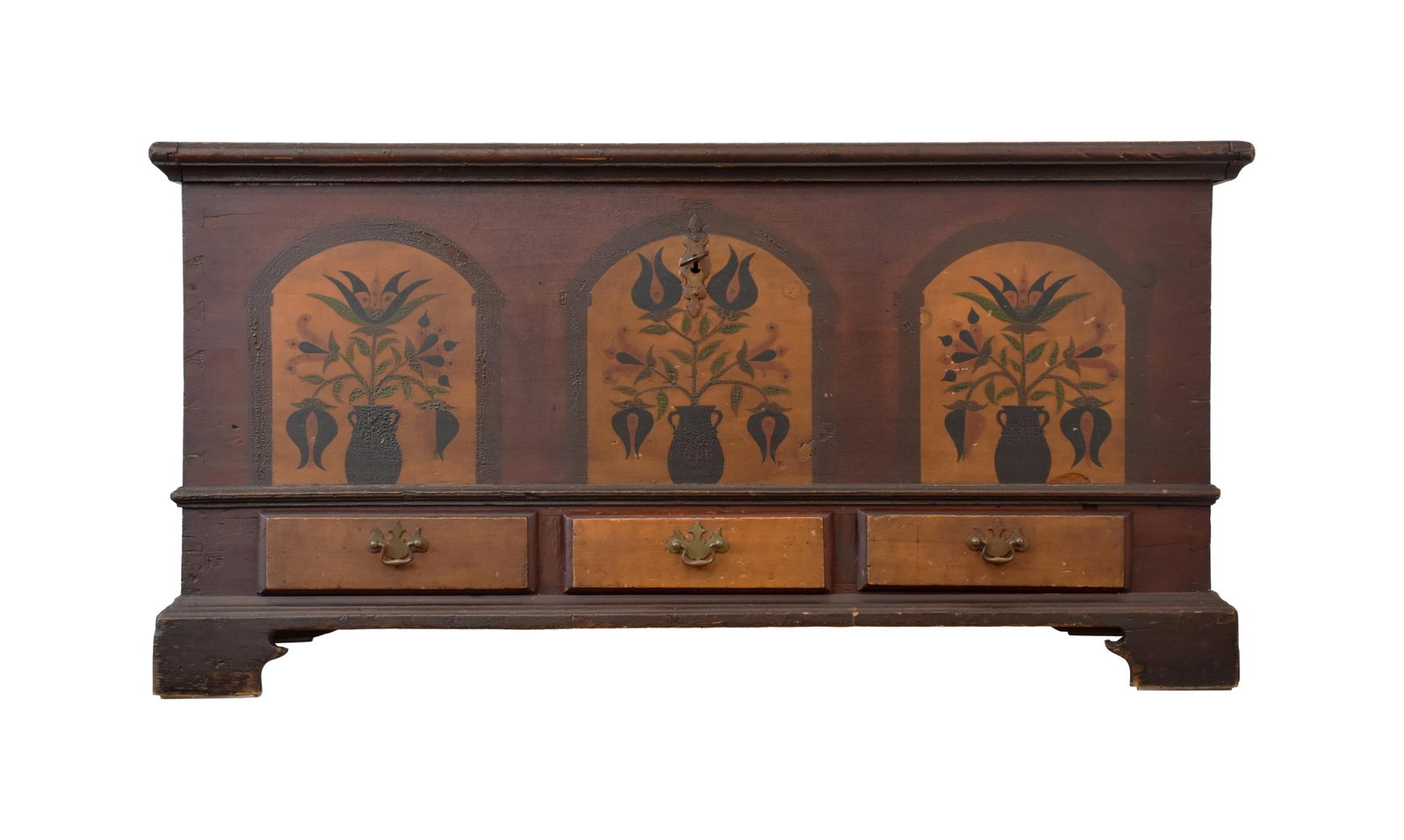 Painted Pennsylvania Tombstone Decorated Chest: Ca. 1800. Pine. Attributed to Johannes Ranck. Depicts three panels of potted plants over three grain painted drawers. Lift top with two panels with geometric designs. Dovetail construction. Breadboard