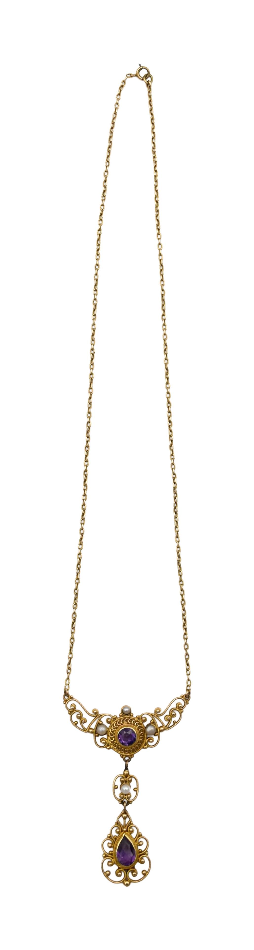 Antique Gold Filigree and Amethyst Necklace: Ca. 1910. 14kt yellow gold. Intricate filigree work. Set with two faceted amethysts and four small pearls. Pendant and drop are marked 14kt; chain tests as 14kt; clasp is marked 10kt. Chain: 16"