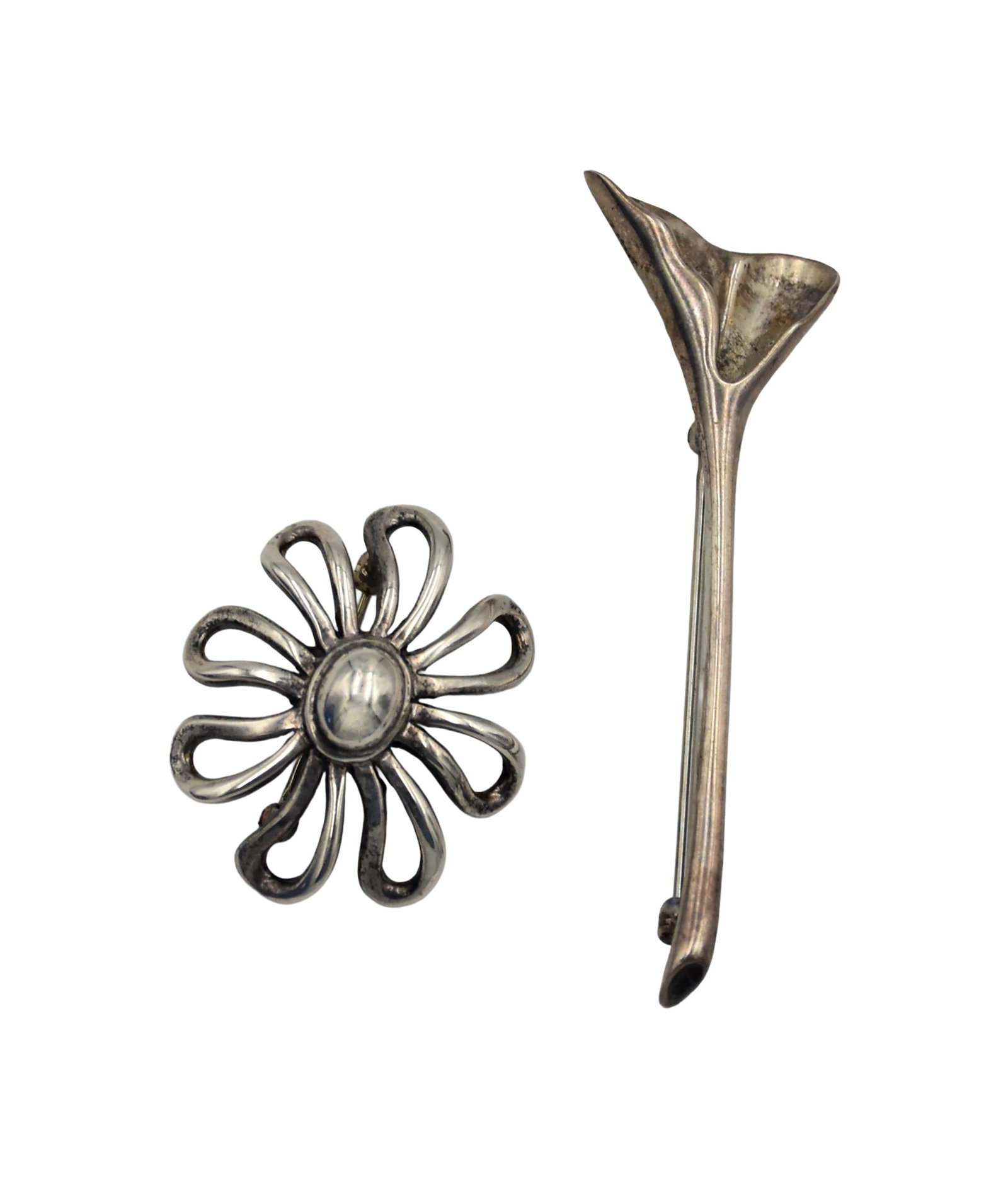 (2) Vintage Tiffany & Co. Brooches: To include: (A) Paloma Picasso sterling silver daisy brooch. 1 1/4" wide. 7.35 grams. (B) Sterling silver Ginko leaf form brooch. 2 1/2" long. 5.00 grams. Comes in a Tiffany & Co. pouch and box.Good
