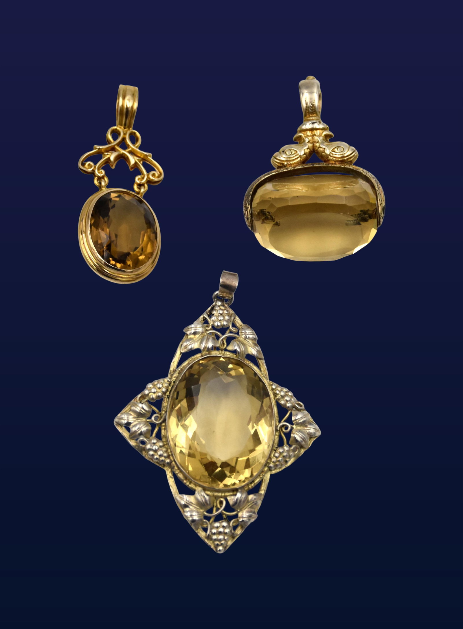 (3) Citrine Pendants and Fob: 19th/20th C. Cut faceted design. To include: (A) Pendant. 14kt tested. 1 3/4" high x 5/8" wide. (B) Watch fob with dolphin design. Swiveling citrine. 14kt tested. 1 1/2" high x 1" wide. (C) Sterling