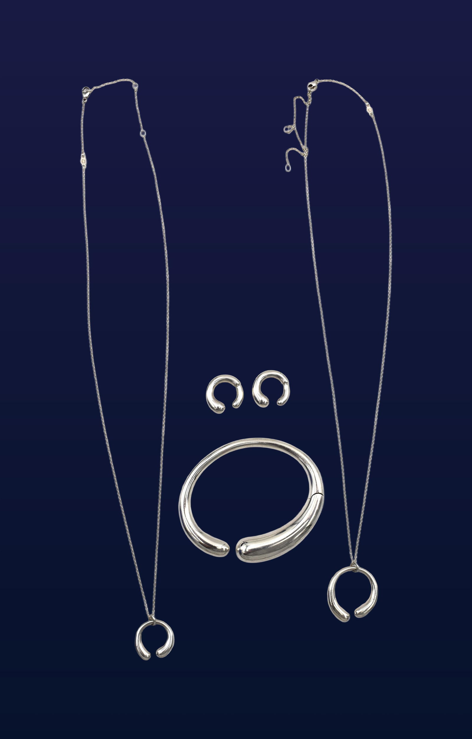 (4) Piece Georg Jensen Jewelry Set: 20th C. Mercy design. Sterling silver. To include: (A) Bracelet. 3" wide. (B) Pair of pierced earrings. 3/4" wide. (C) Necklace. 21" long with 3/4" pendant. (D) Necklace. 21" long with 1 1/8" wide