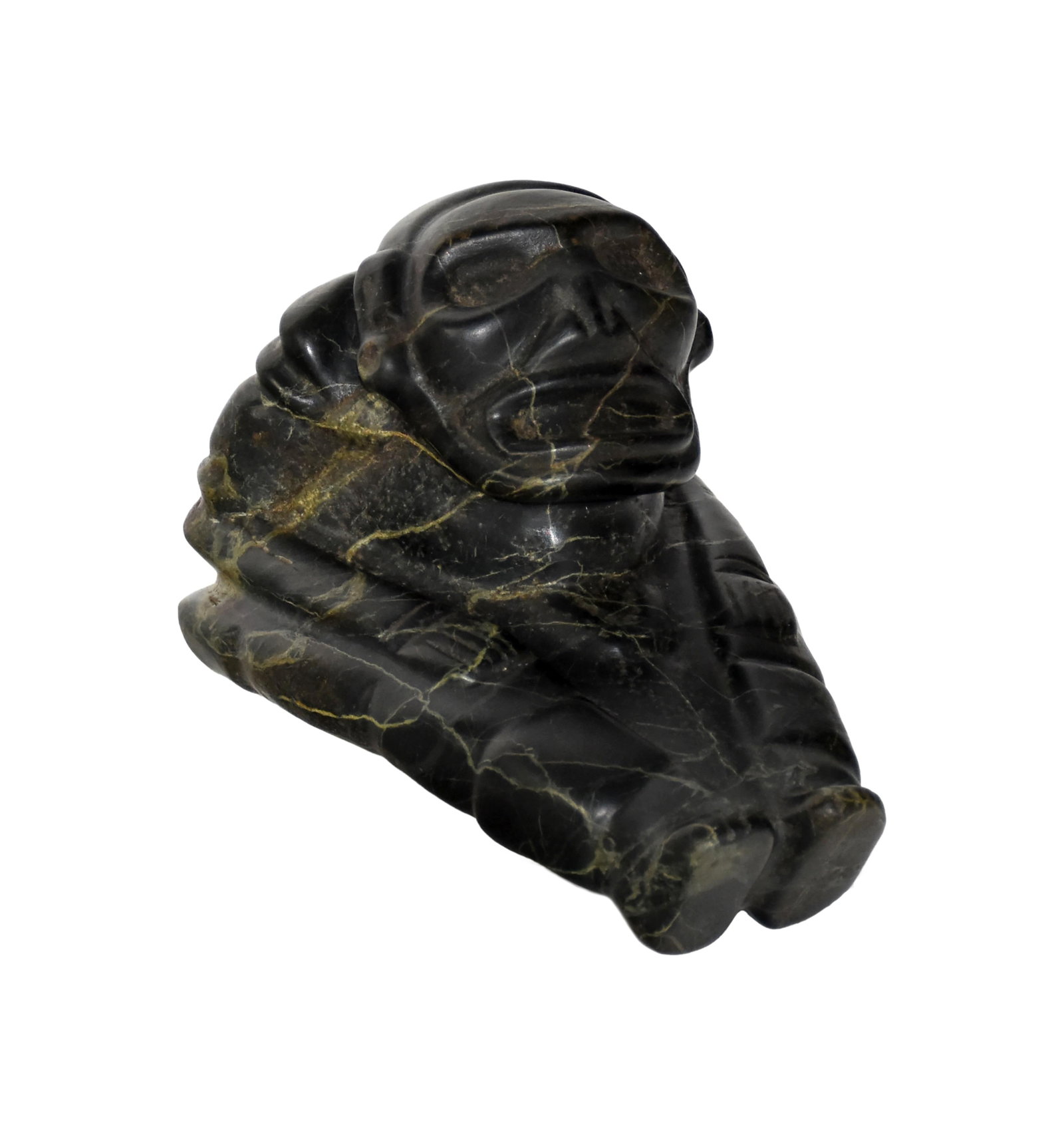 Taino Sculpture: Ca. 600-1500 AD. Black marble with light green serpentine inclusions. 5 1/2" high x 5 1/4" wide x 7 1/4" long. Taino sculpture of a cacique or important elite carved in three dimensions. He is bent