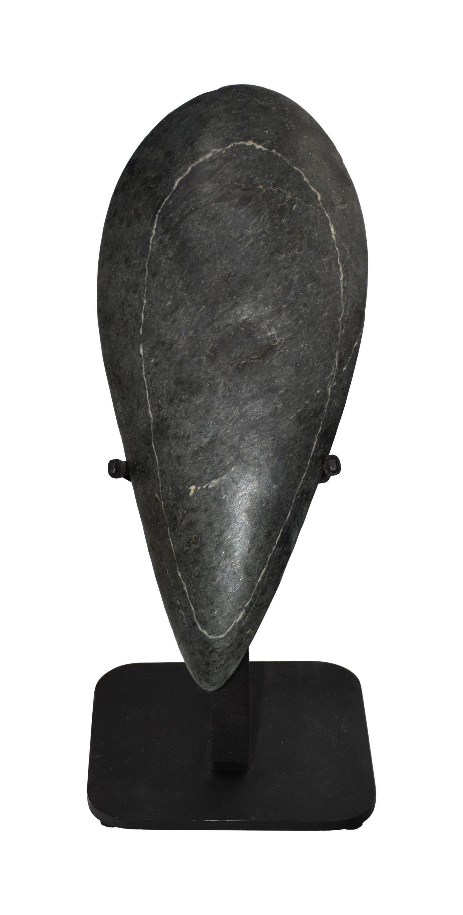 Taino Anthropic Petaloid Celt: Ca. 600-1500 AD. Jade from the Rio San Juan in the Dominican Republic. 12 3/8" high x 5 3/4" wide. Fully relief-carved body. The hero may be an ancestor. At the center of the celt is an engraved