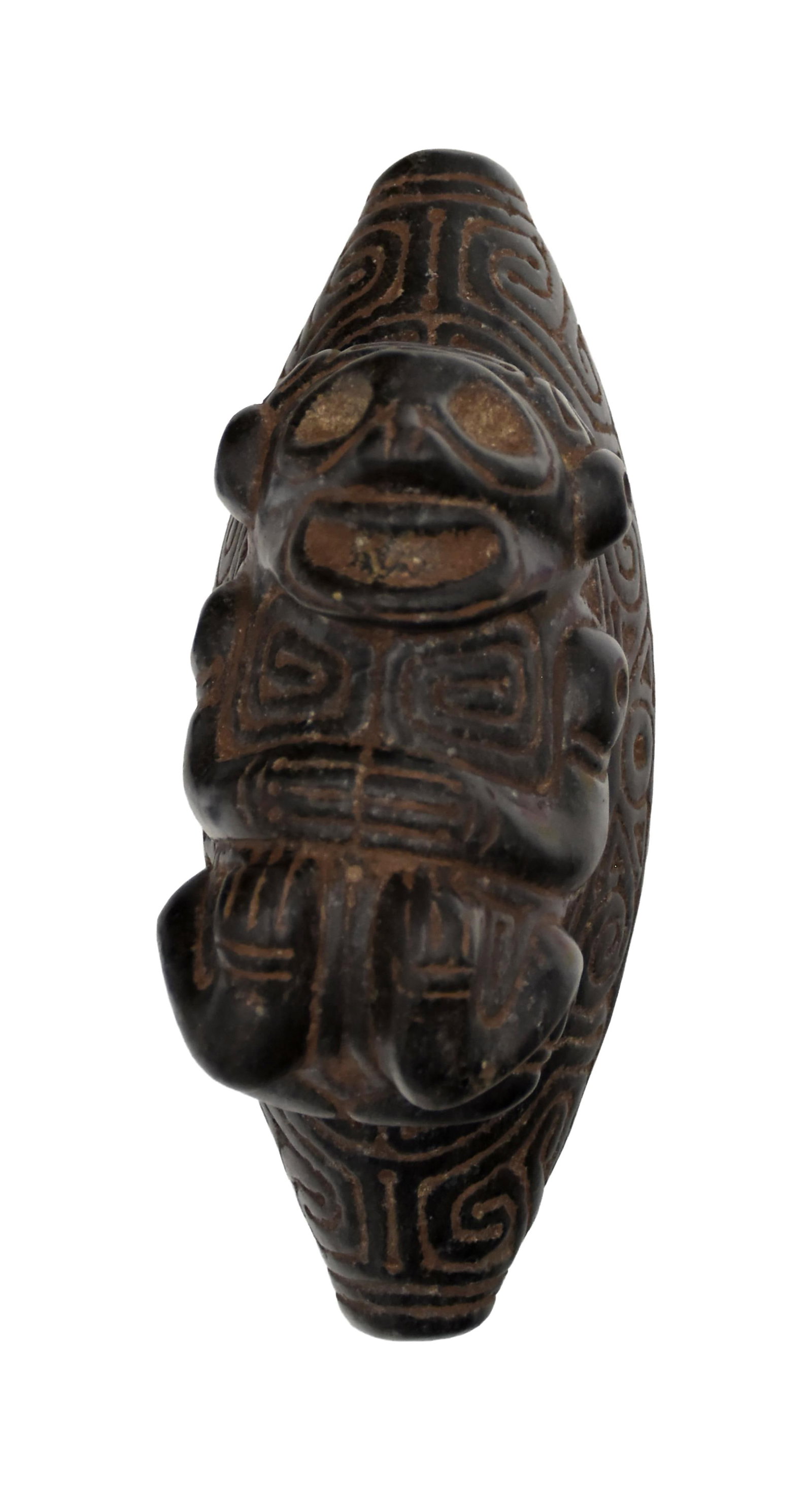 Taino Zemi, Type 5: Ca. 600-1500 AD. Igneous magnetite. 3 1/4" high x 6 1/4" wide x 2 1/2" deep. The usual head form has been modified to represent a reclining ancestor. The front and back portions are carefully incised 