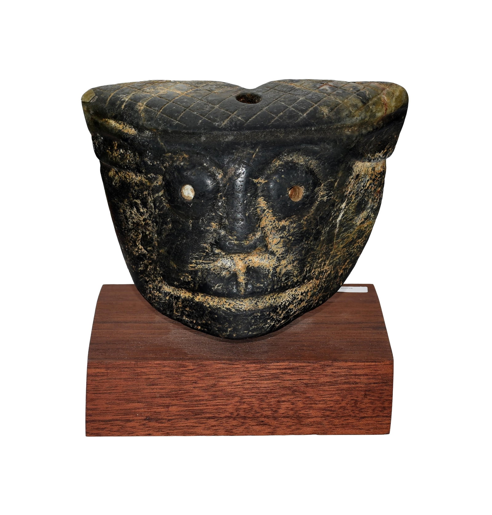 Pre-Columbian Stone Carving: Face image. 5" high x 6 1/2" wide x 3" deep. Mounted on a modern custom made wooden stand measuring: 1 1/2" high x 6" wide x 5" deep.Shows a minor chip to upper corner. Age appropriate wear.