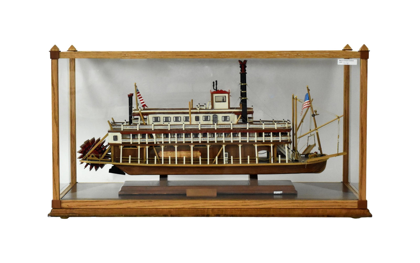 Wooden Ship Model of a Paddle Wheel Steamboat: Late 20th C. KING OF MISSISSIPPI. Fully rigged. Model: 13" high x 24" wide x 5" deep. In a custom-made oak case measuring: 15 1/2" high x 29 1/4" wide x 11 1/4" deep.Good condition. Not removed from