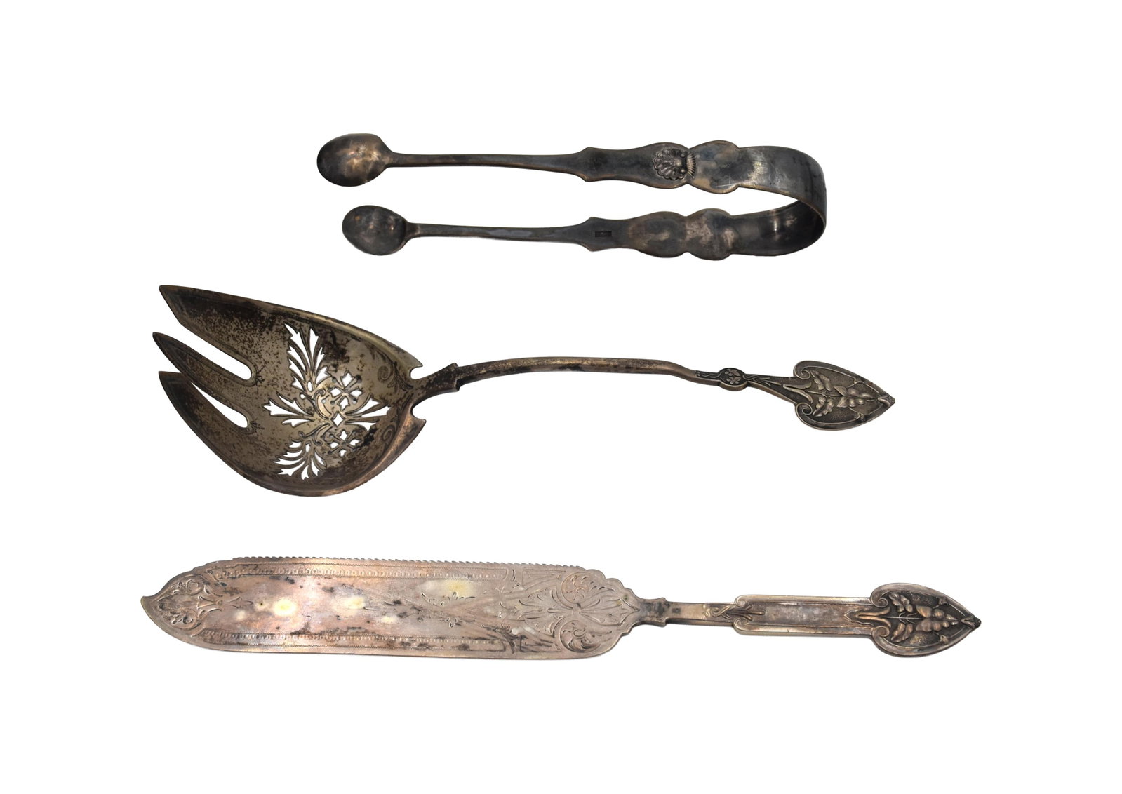 (3) Coin Silver Serving Pieces: To include: (A) Sugar/ice tongs. 6 1/2" long. (B) Pierced serving fork. Decorated handle. 9 1/4" long x 2 3/4" wide at bowl. (C) Fish knife. 10" long x 1 1/2" wide. 12.16 total ozt.Condition