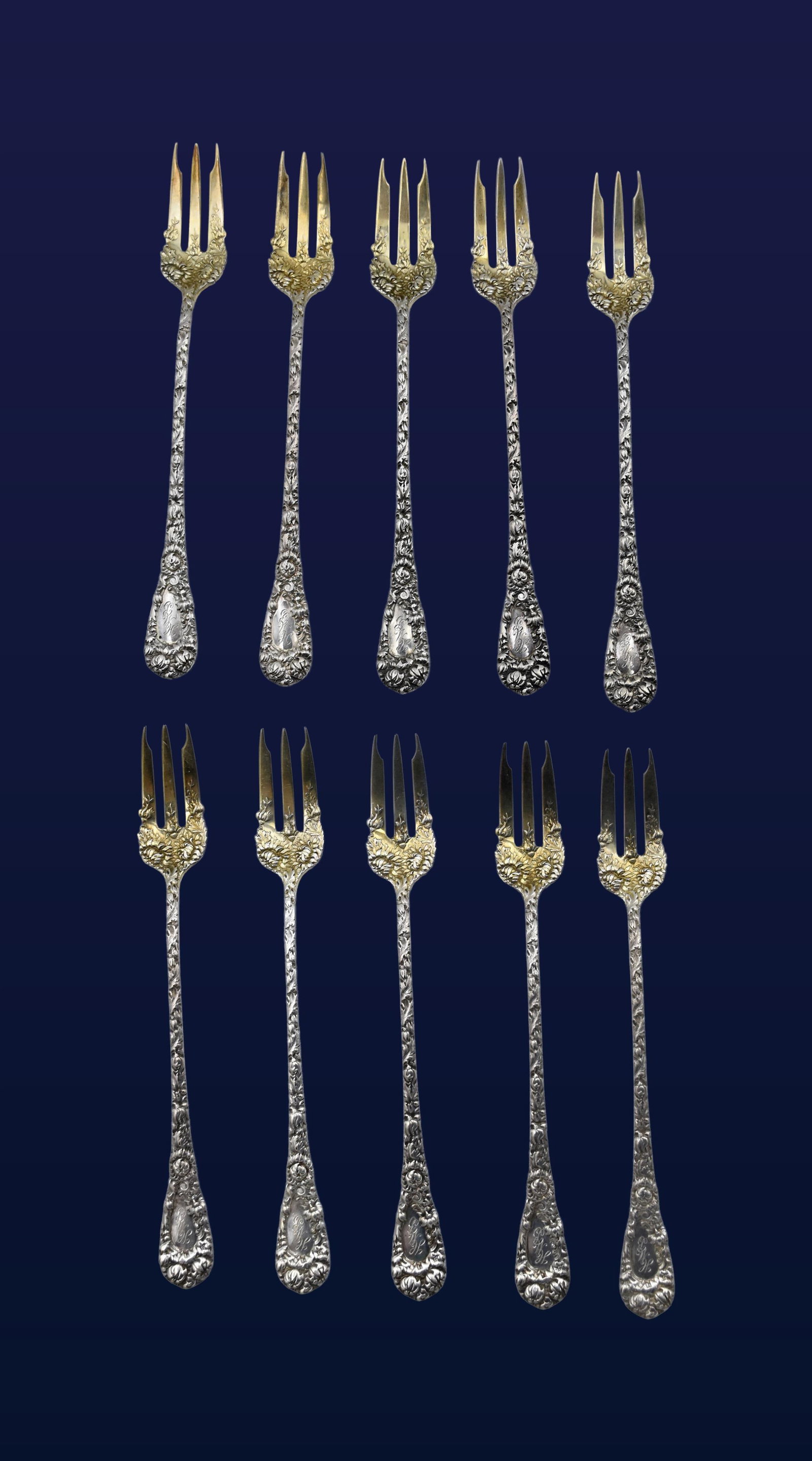 (10) Sterling Silver Cocktail/Oyster Forks: Late 19th C. Embossed floral design with traces of gold wash to bowl/fork area. Stamped sterling. 5 1/4" long. 5.25 ozt. Provenance: Estate of Alfred J. Walker, legendary art dealer and collector.