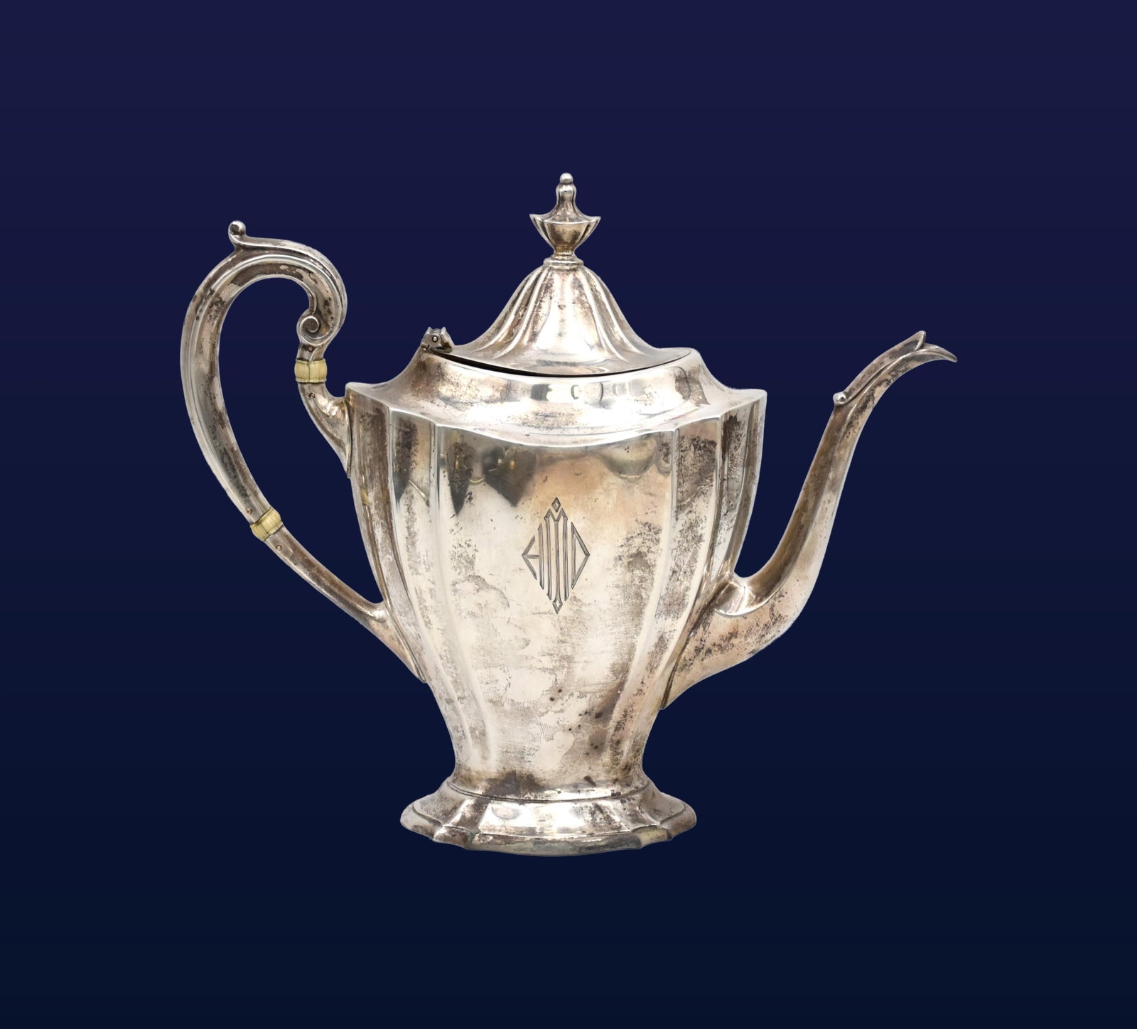 Sterling Silver Teapot: 20th C. Stamped Reed & Barton sterling on bottom. Hinged domed lid, urn-form finial, scroll handle with insulating spacers. 2-pint capacity. 9" high x 10" wide from spout to handle. 23.47 ozt.Good