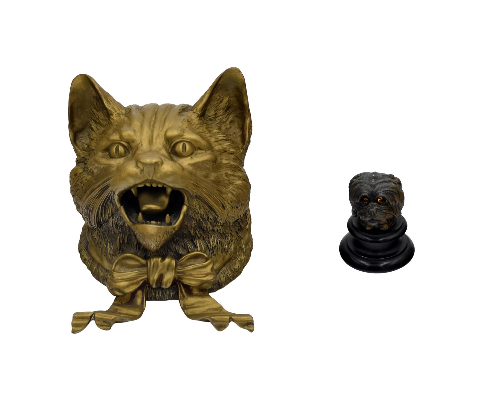Inkwell and Thimble holder: Late 19th/Early 20th C. To include: (A) Brass inkwell. Large cat. Head opens to reveal ink receptacle. 4" high x 5" wide x 5" deep. (B) Metal thimble holder. Dog with glass eyes mounted on a wooden