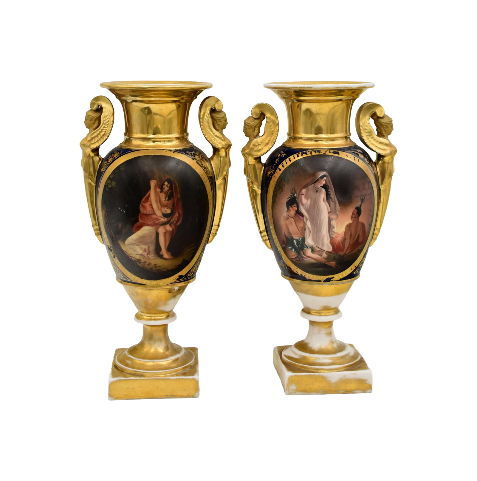 Pair of Classical Urns: 19th C. Probably Sevres. Unmarked. Figural winged female handles. One shows painted design with two Native Americans and a maiden. The other depicts a young man and woman embracing. 12 1/2" high x 7"