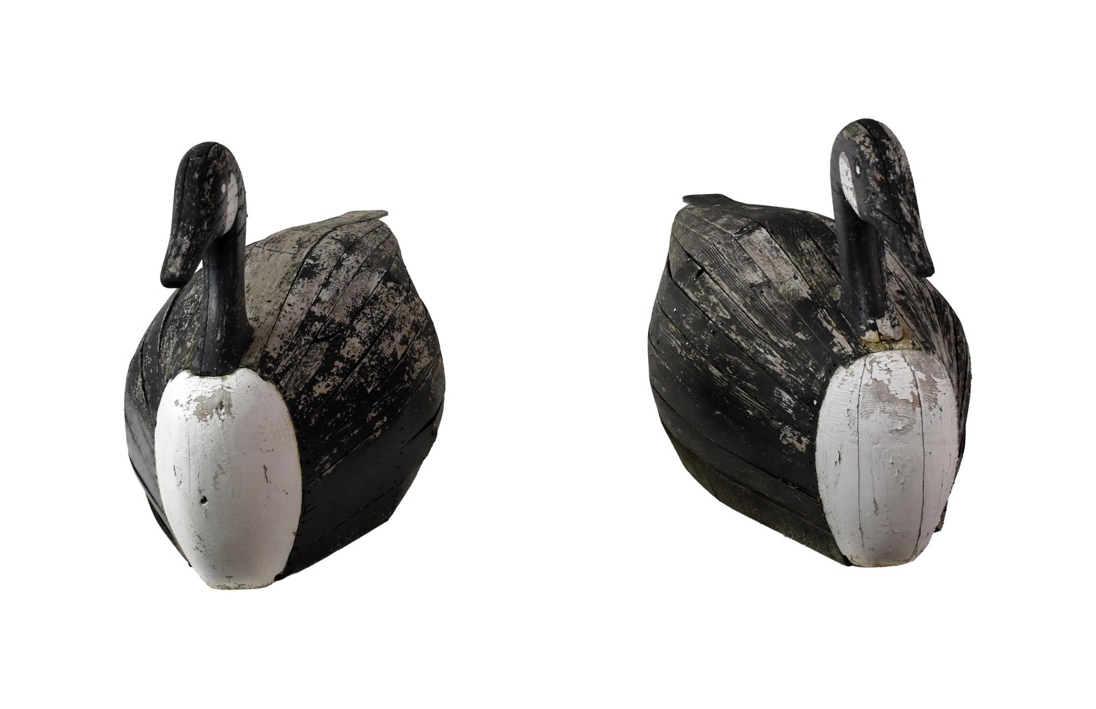 (2) Oversized Slat Decoys: Early 20th C. Canada geese. 26" high x 52" wide x 20" deep. These have been outside for many years. They show paint loss, deterioration to undersides, and one head has been repaired. IMPORTANT-