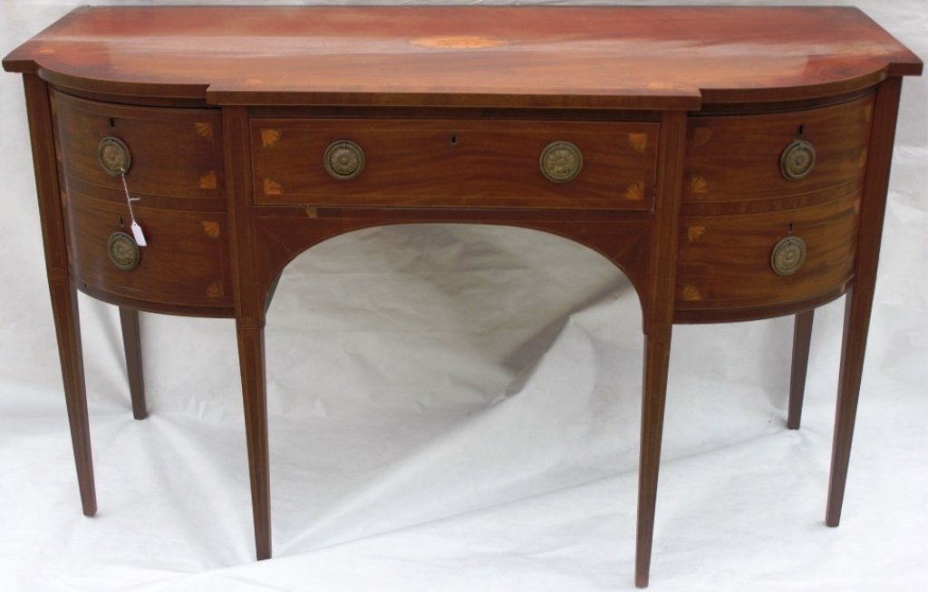 GEORGE III INLAID MAHOGANY SIDEBOARD DEMILUNE TOP: WITH FAN SHELL AND LINE INLAY, PULL OUT BOTTLE DRAWER, OLD BRASS HARDWARE, MINOR VENEER LOSS, OAK AND DIEHL SECONDARY WOODS, 36" HIGH, 61" WIDE, 27" DEEP.