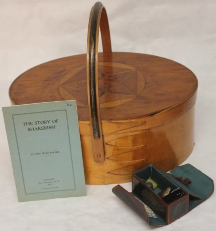 SHAKER OVAL SEWING BOX, FIVE FINGER INLAID TOP,: REINFORCED HOOP HANDLE WITH LEATHER SEWING CASE AND SHAKER PAMPHLET, INLAY NOT ORIGINAL, CRACK TO TOP, MISSING PIECE ON RIM, 5 1/2" HIGH X 13 1/2" LONG, 12" OVERALL HEIGHT.