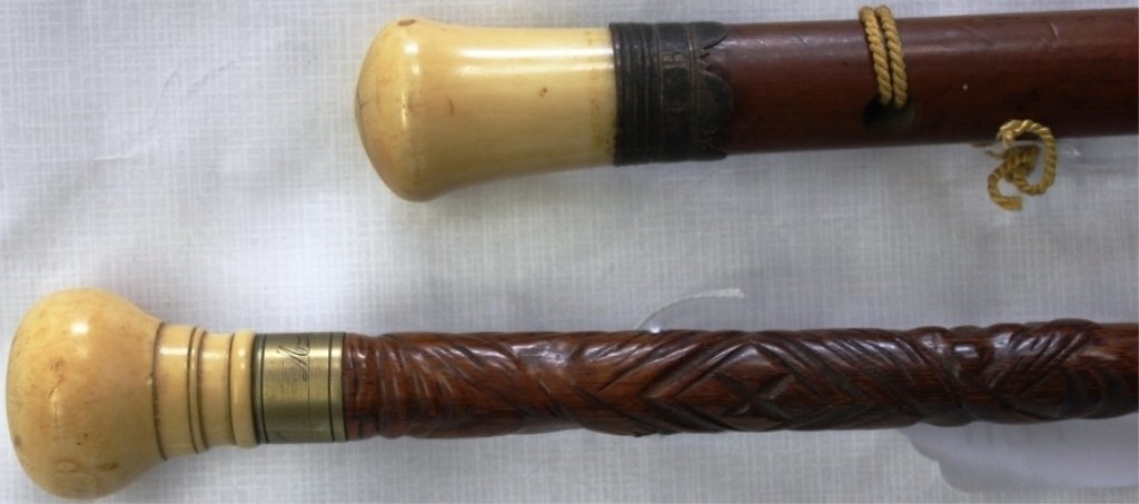 TWO CANES WITH IVORY HANDLES, 19TH C, ONE IS: 33" LONG WITH A SILVER MOUNT, THE OTHER IS 35" LONG AND HAS A ROSEWOOD SHAFT WITH BRASS BAND, ENGRAVED M. LEACH.
