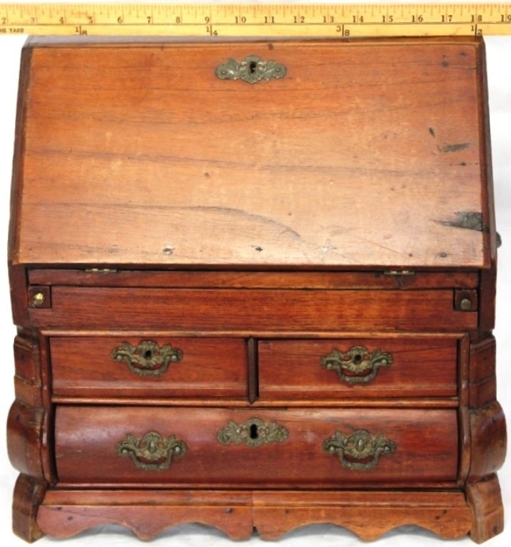 MINIATURE 19TH C CONTINENTAL SLANT LID DESK WITH: BOMBE FRONT, ORIGINAL BRASS HARDWARE, FITTED INTERIOR WITH ETCHED GLASS DOOR, MINOR IMPERFECTIONS, 16" HIGH, 15 3/4" WIDE, 9 1/2" DEEP.