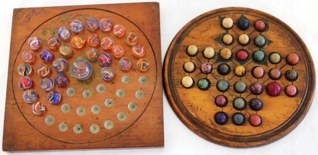 TWO 19TH C MARBLE GAMES, ONE WITH 33 CLAY MARBLES,: THE OTHER WITH 33 BLOWN SWIRL GLASS MARBLES ON WOODEN GAME BOARDS, ONE WITH GEOMETRIC DESIGN, 8" DIAMETER AND ONE WITH SWIRL DESIGN, 8" X 8."