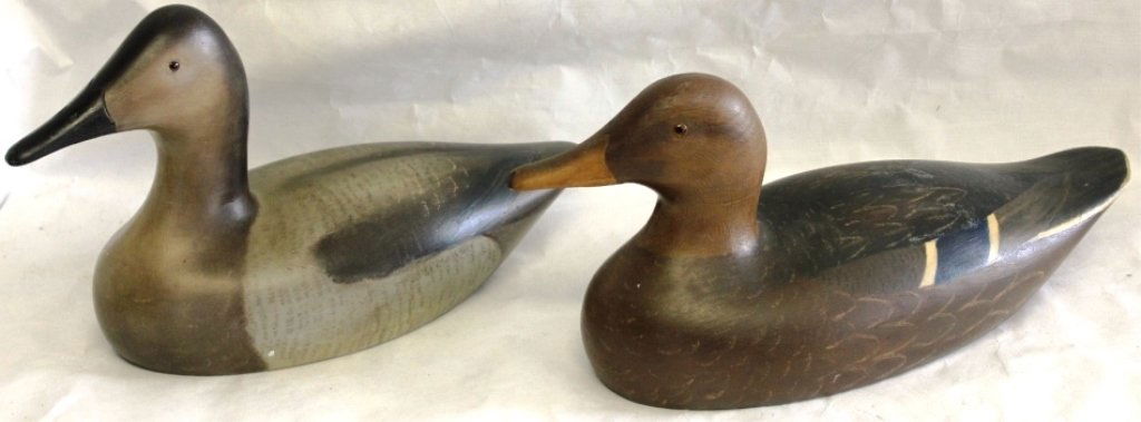 PAIR OF WOODEN DUCK DECOYS BY MATTAPOISETT: MAKER, HOLGER SMITH, DATED 1973, STAMPED ON BOTTOM, CANVAS BACK HEN AND MALLARD HEN, EXCELLENT ORIGINAL CONDITION, ONE MEASURES 14" LONG, THE OTHER IS 15" LONG.