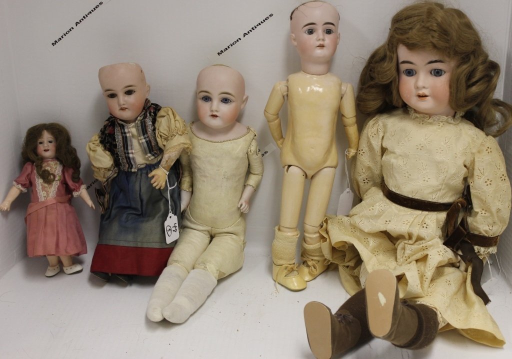 FIVE BISQUE HEAD DOLLS TO INCLUDE ONE S*H MARK,: "5500", REPAIRED HEAD, BLUE SLEEP EYES, OPEN MOUTH, COMPOSITION BODY, 24"; A "154", BLUE EYES, OPEN MOUTH, COMPOSITION BODY, 16"; ONE CK "165", BROWN SLEEP EYES, OPEN MOUTH, COMPOSITION BODY, 14 1/2";