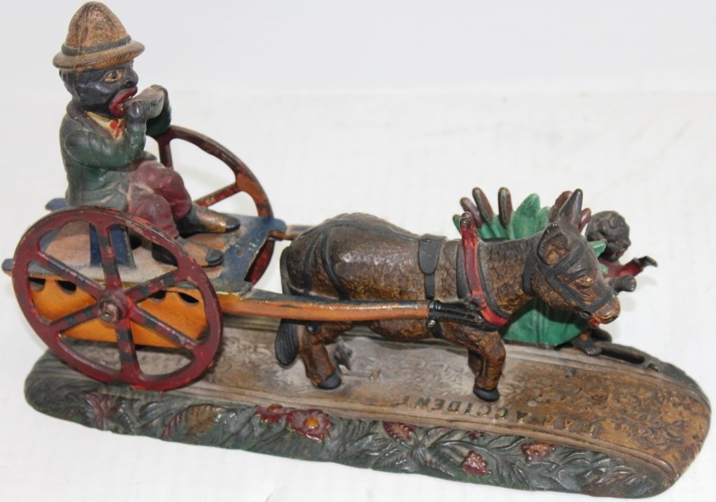 LATE 19TH C CAST IRON MECHANICAL BANK BY: J. E. STEVENS "BAD ACCIDENT"; GOOD CONDITION WITH NICE ORIGINAL PAINT; PLATE ON BOTTOM OF BANK IS MISSING; WORKING CONDITION; 6" HIGH, 10 1/4" LONG, 3 3/8" WIDE