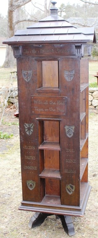 CA 1900 AMERICAN OAK TABARD INN REVOLVING: BOOKCASE, "THE HOMES OF THE AMERICAN PEOPLE - THE BEST READING ROOMS IN US." FOUR SIDED CARVED WITH HERALDIC SCENES, ORIGINAL FINISH, MINOR DAMAGE; 78" HIGH, 26 1/2" X 26 1/2"