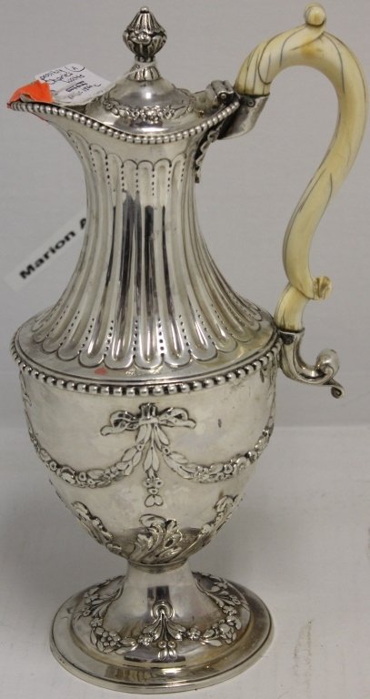 LATE 18TH C ENGLISH STERLING SILVER HANDLED EWER: POSSIBLY CHARLES WATTS, LONDON; RAISED REPOUSSE DESIGN WITH CLASSICAL STYLE GARLANDS, CARVED IVORY HANDLE; HANDLE SHOWS MINOR HAIRLINES; 12" HIGH, WEIGHS 29.3 OZT INCLUSIVE OF HANDLE; PROVENANCE CALVI