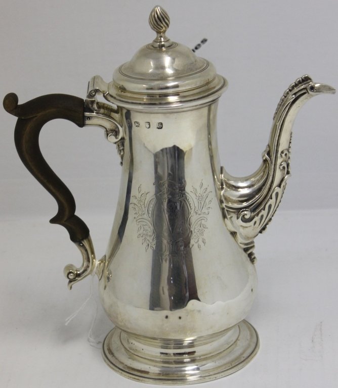 ENGLISH STERLING SILVER 18TH C COFFEE POT: THOMAS WHIPHAM AND CHARLES WRIGHT, 1763 LONDON, WEIGHS 30.2 OZT; 10 1/4" HIGH, 9" WIDE; HAS ENGRAVED HERALDIC SHIELD, CARVED WOODEN HANDLE, 6 SMALL DENTS IN LOWER BODY OF PIECE; PROVENANCE CALVIN BULL