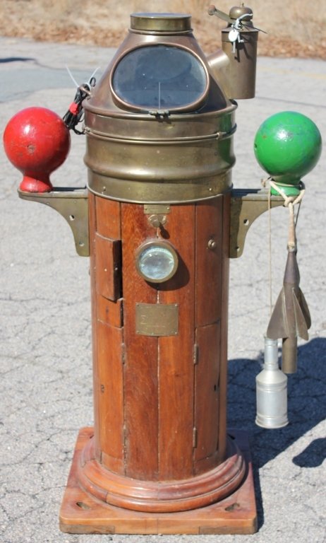 EARLY 20TH C BRASS AND WOODEN BINNACLE FROM THE: SHIP ACADIA; IVY COMPASS KELVIN & HUGHES; MANUFACTURED IN GREAT BRITAIN ALONG WITH TRAIL LOG AND FLASHLIGHT; 53" HIGH, 33" WIDE, 14" DEEP