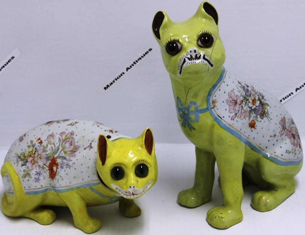 2 19TH C PORCELAIN ANIMALS BY EMPIRE WORKS STOKE: ON TRENT, ENGLAND; CAT NODDER WITH BLOWN GLASS EYES; 6 1/2" HIGH X 10" LONG; AND A SEATED DOG; SMALL HAIRLINE ON CAT AND DOG HAS LARGE CRACK AND BROKEN FOOT; 12" HIGH, 8" WIDE