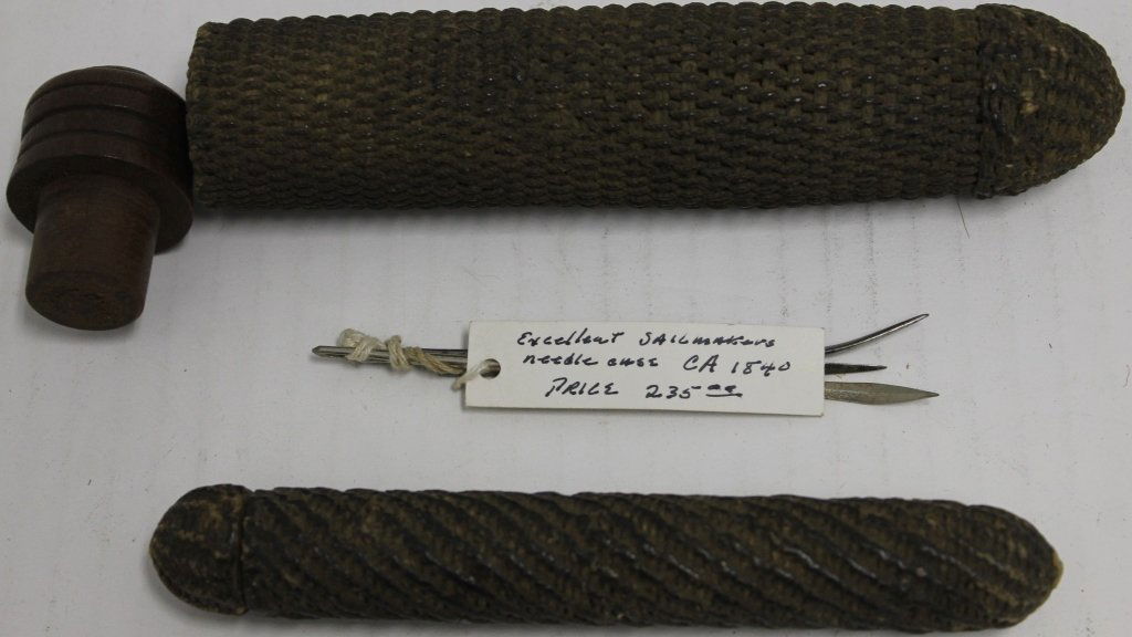 2 ANTIQUE SAILOR MADE NEEDLE CASES; ONE IS: BRAIDED MARLIN CORD, 7 1/2" LONG WITH TURNED WOOD TOP AND 3 NEEDLES; THE OTHER IS 5 1/2" LONG, MADE OF BRAIDED MARLIN CORD; DAVID ARMS COLLECTION