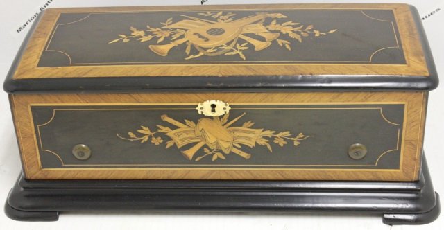 INLAID SWISS MUSIC BOX, 8 TUNES, NO DAMAGE: TO TEETH, GOOD WORKING CONDITION, MUSICAL INSTRUMENT INLAY ON TOP AND FRONT. 7" HIGH, 19" WIDE, 9" DEEP.