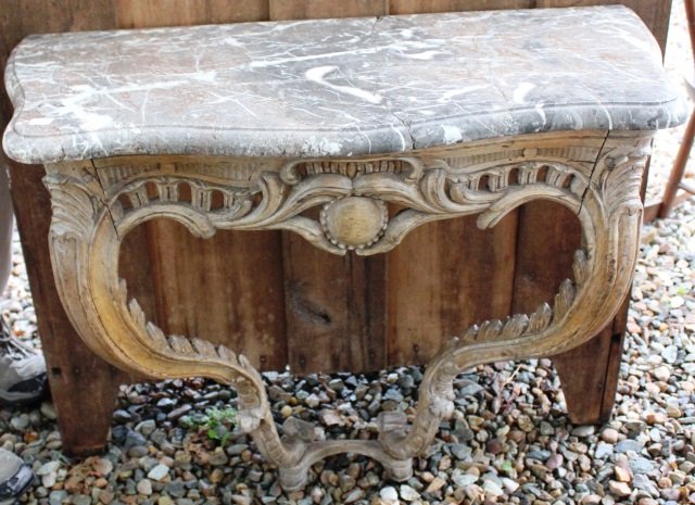 18TH C FRENCH CONSOLE TABLE, ROCOCO CARVING WITH: SHAPED MARBLE TOP. TOP WAS BROKEN IN TWO AND REPAIRED. 29" HIGH, 31 1/2" WIDE, 15 3/4" DEEP.