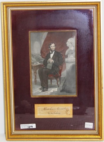 ABRAHAM LINCOLN CLIPPED SIGNATURE, FRAMED WITH: A COLORED ENGRAVING DEPICTING LINCOLN SEATED IN A VICTORIAN CHAIR. AUTHENTICATION FROM CHARLES HAMILTON (AUTOGRAPH SPECIALIST) ON THE BACK.
