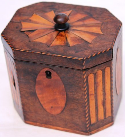 EARLY 19TH C CONTINENTAL TEA CADDY, OCTAGONAL: FORM, OVAL INLAID PANELS, MINOR VENEER LIFTING, 5" HIGH, 4 3/4" WIDE, 3 3/4" DEEP.