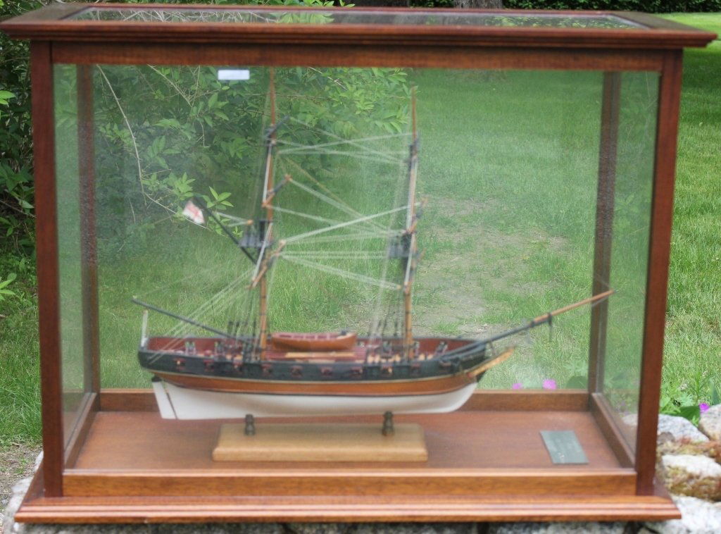 EXCEPTIONAL SHIP MODEL OF THE H.M.S. RAVEN, 20: GUN BRIG, 1805, CIRCA 1970 BY DOCTOR W. E. DAWSON, MARION, MASS RESIDENT AND NOTED SHIP MODEL BUILDER. IN A CUSTOM MADE MAHOGANY AND GLASS CASE. CASE IS 25 1/2" HIGH, 34" WIDE, 17" DEEP. SHIP IS APPRO