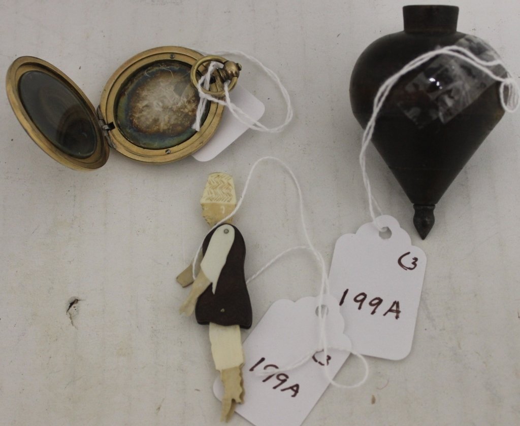 3 ITEMS FROM WHALING MERCHANT G. R. PHILLIPS: (GEORGE PHILLIPS) OF NEW BEDFORD TO INCLUDE A GOLD FILLED LOCKET WITH A LOCK OF HAIR, 1 1/2" DIAMETER, A TOP 3" AND A WHALE BONE AND WOOD FIGURE 3" (WITH DAMAGE - HAND MISSING).