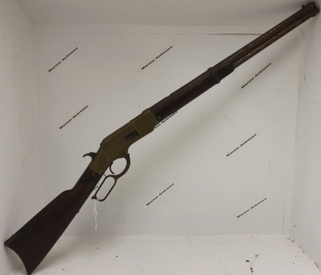 ANTIQUE WINCHESTER HENRY RIFLE, OPEN TOP GUN: WITH SADDLE RING. SERIAL NUMBER 160917. MISSING LOADER TUBE CAP, ONE REPAIR AND ONE CHIP ON STOCK, MISSING ONE SCREW ON REAR OF MAIN TANG, ONE SMALL CRACK ON FOREARM. HOLD DOWN LATCH FOR LEVER MISSING