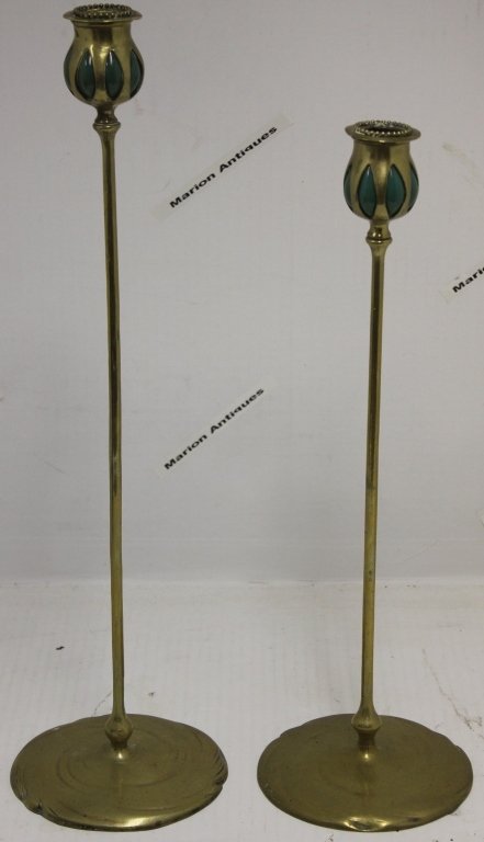 TWO TIFFANY STUDIOS BRONZE CANDLESTICKS WITH: BLOWN GLASS INSERTS. ONLY ONE IS MARKED TIFFANY ON THE BASE, MODEL 21100, STICKS HAVE BEEN POLISHED, 17 1/2" HIGH AND 20 1/4" HIGH.