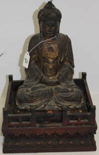 CARVED ASIAN BUDDHA, JAPANESE 18TH C, PAINTED: GILT AND LACQUERED FINISH, MINOR LOSS TO LACQUER, UNTOUCHED ORIGINAL CONDITION FROM AN EARLY 20TH C COLLECTION 14 1/2" H, BUDDHA IS 10 1/2", BASE IS 9 1/2" X 8 1/4"..