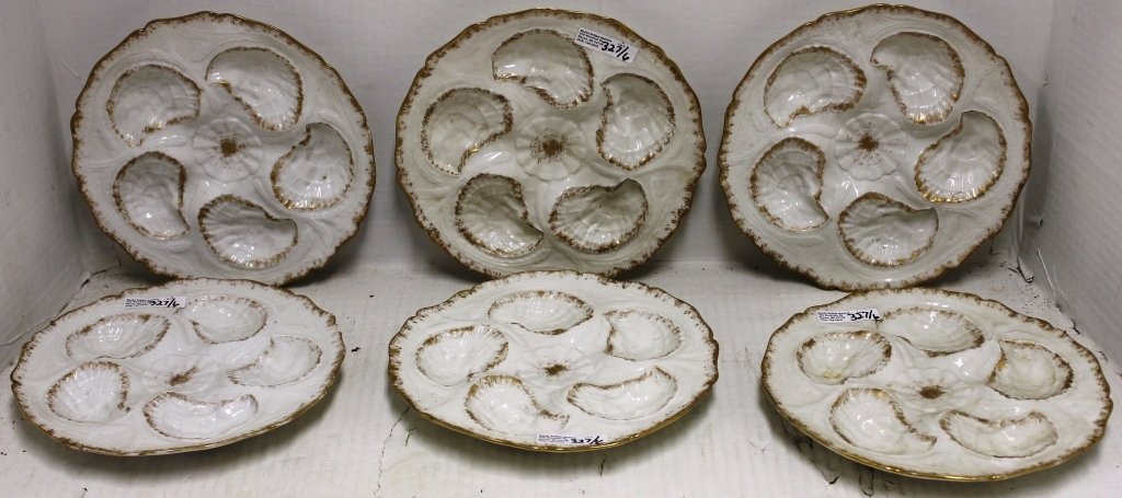 SIX ODD LIMOGES OYSTER PLATES, 9" DIAMETER. ONE: HAS A CHIP AND SMALL HAIRLINE.