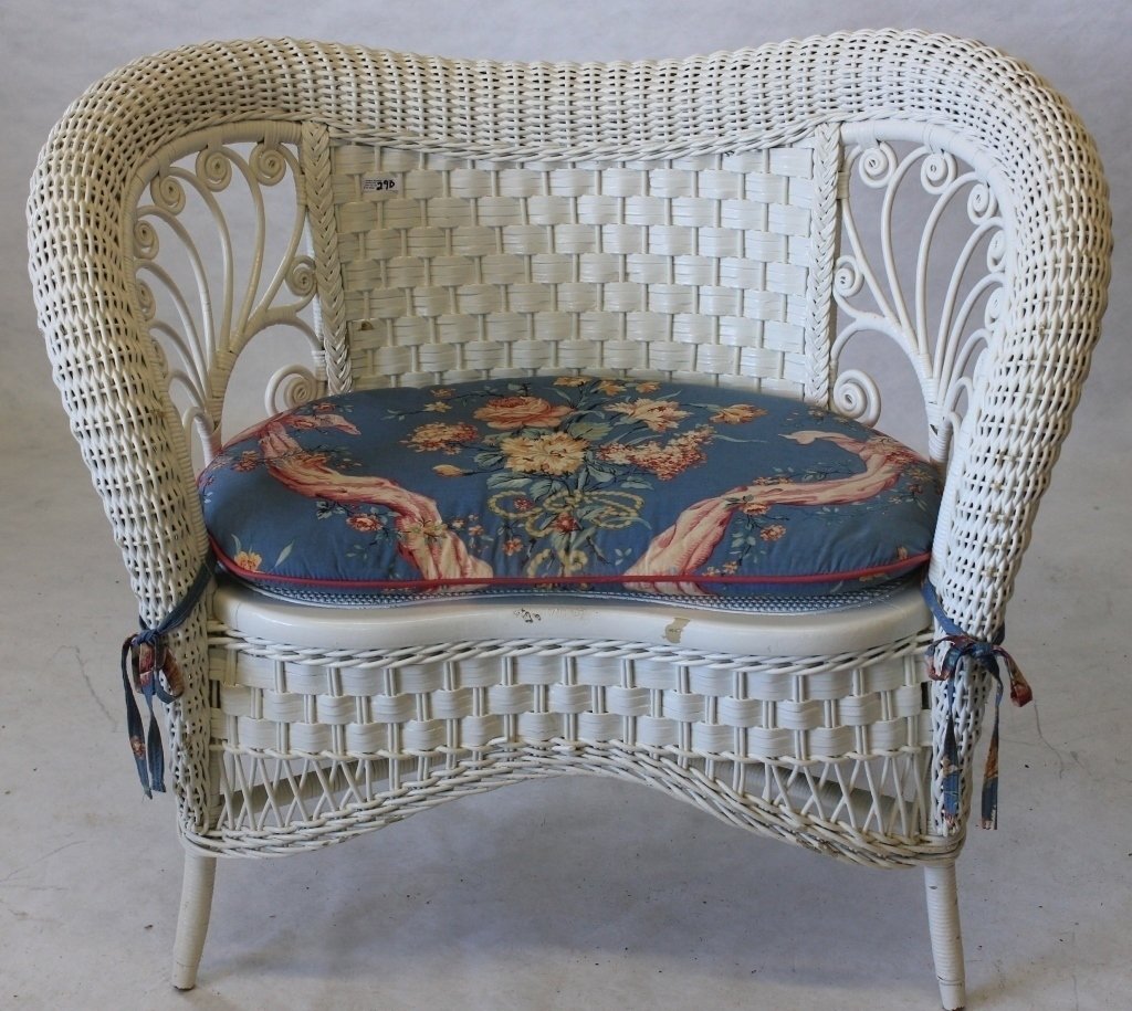 RARE AMERICAN WICKER KIDNEY SHAPED LOVESEAT,: CA 1898, HEYWOOD BROS. WAKEFIELD CO., WHITE PAINTED FINISH. SHOWS SOME MINOR CHIPS TO PAINT, CANE SEAT, 30 1/2" HIGH, 36 1/2" WIDE, 20" DEEP. FROM THE ESTATE OF KITTY MELLON.