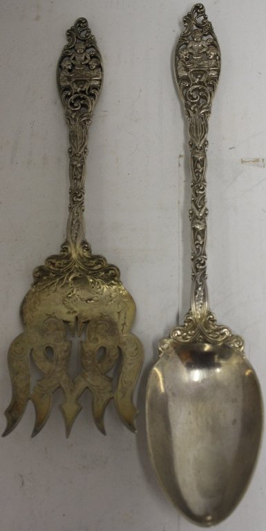 AMERICAN LATE 19TH C ORNATE SILVER SERVING FORK: AND SPOON WITH SEATED CHERUBS AT DINNER TABLE, ENGRAVED LOBSTERS ON FORK. FORK 9 3/4", SPOON 11 1/4". 10.36 TROY OZ.