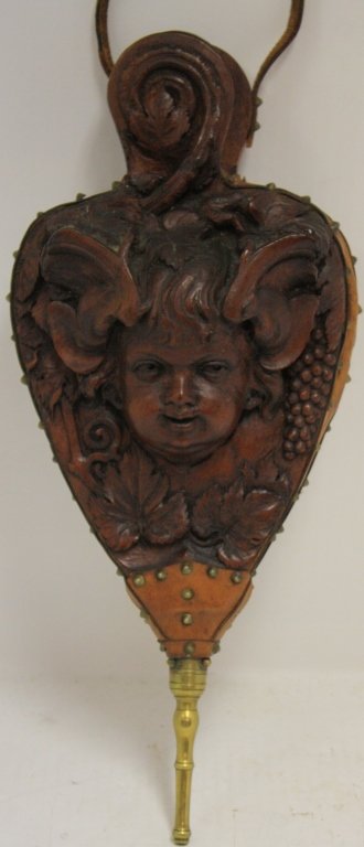 19TH C CARVED WOODEN BELLOWS DEPICTING A: BACCHANALIAN FIGURE WITH LEATHER TRIM. FROM THE EDDY HOMESTEAD, MIDDLEBORO, MA. CARVED FROM A TREE NEXT TO THE HOUSE. 19" LONG X 8" WIDE.