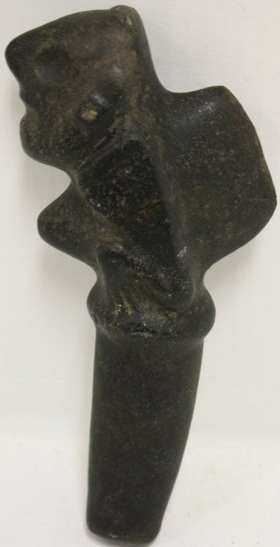 PRE-COLUMBIAN TAINO FIGURATIVE STONE DAGGER: 1300 AD - 1500 AD. FINELY CARVED WITH FROG DESIGN, DENSE DIORITE BLACK. FOUND IN A CAVE IN THE DOMINICAN REPUBLIC IN 1940. 10 1/4" LONG.