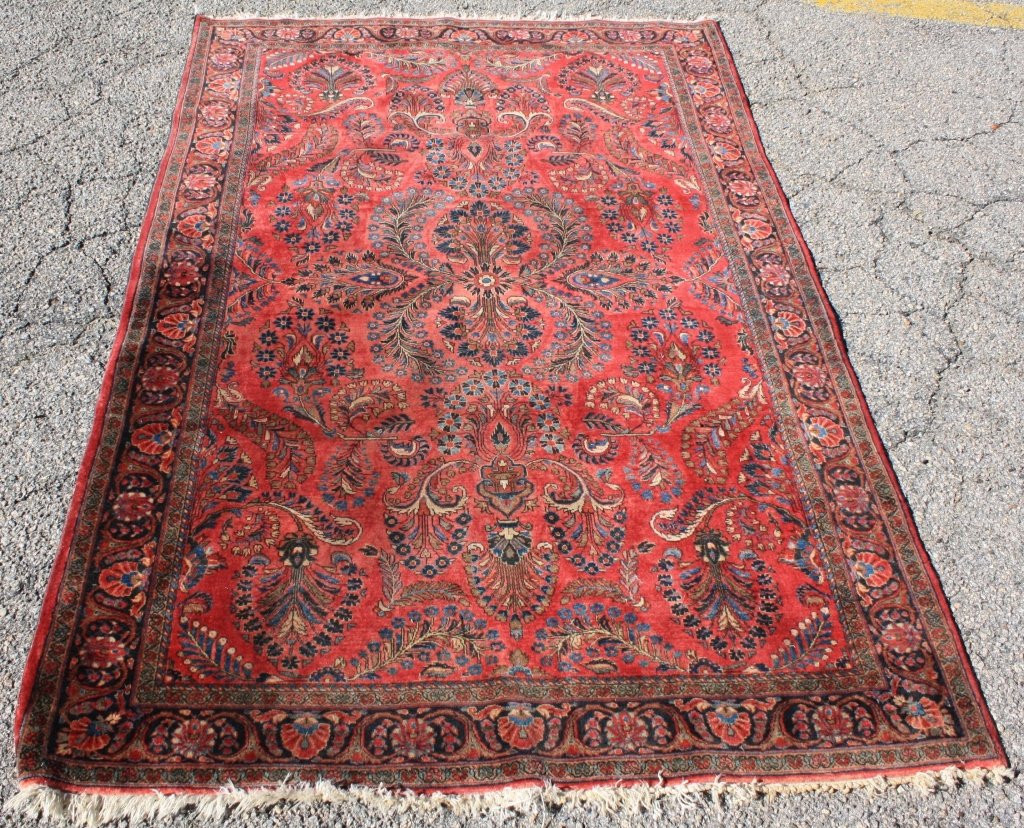 CA 1920 PERSIAN SAROUK CARPET, OVERALL FLORAL: DESIGN, SOFT RED FIELD WITH GOLD AND BLUE HIGHLIGHTS. EXCELLENT ORIGINAL CONDITION WITH SLIGHT WEAR TO FRINGE. 4' 2" X 6' 4 1/2".